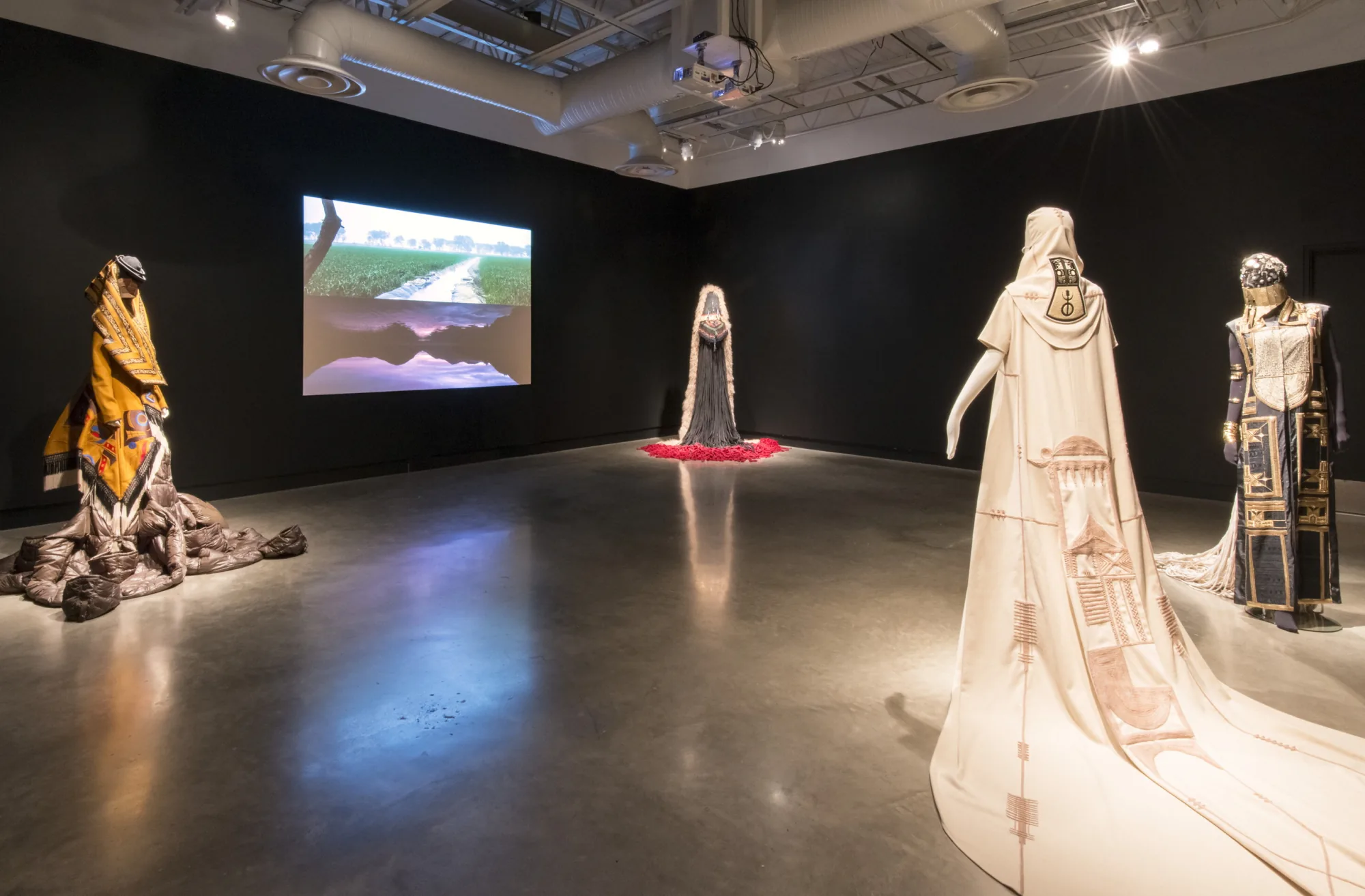 Installation view — SHE in Mud, Sky, Light and Shadow Form, from No Pigs in Paradise, 2015–16, with Indian Land, 2016, made with Nicholas Galanin